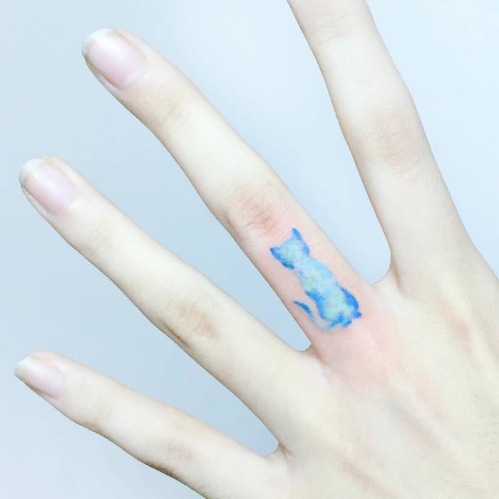 Blue Ink Cat Tattoo On Finger by tattooist IDA