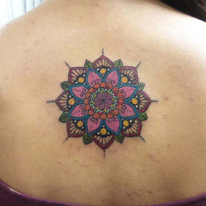 Upper back colored mandala tattoo by Charlotte Dolce