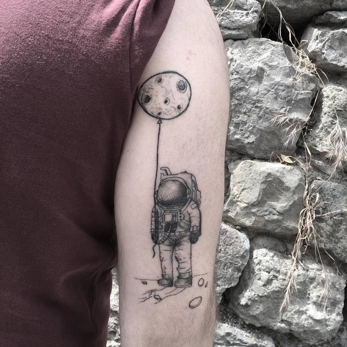 Astronaut Tattoo Holding the Moon by Resul Odabas