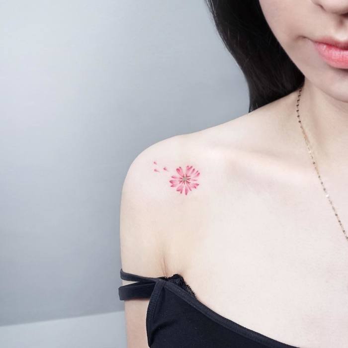 Delicate miniature flower tattoo by Tattooist Ida