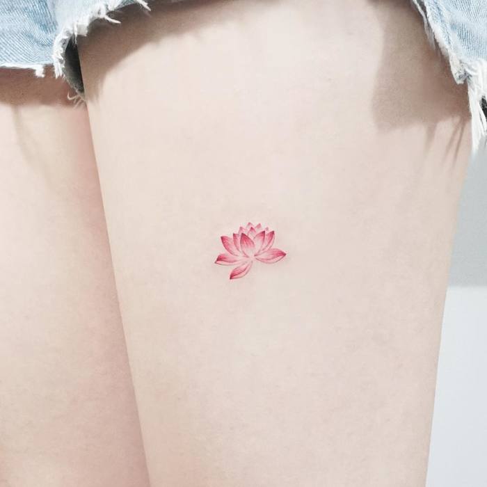 Delicate lotus flower tattoo by Tattooist Ida
