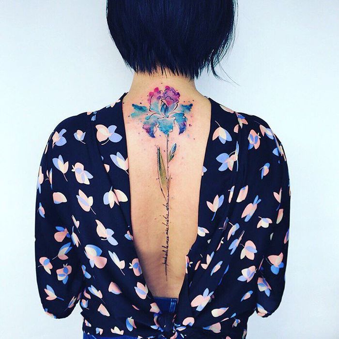Multicolored Iris Tattoo on Spine by Pis Saro