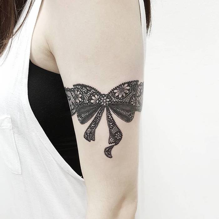 Lace Bow Tattoo on Arm by jeffchewtattoo