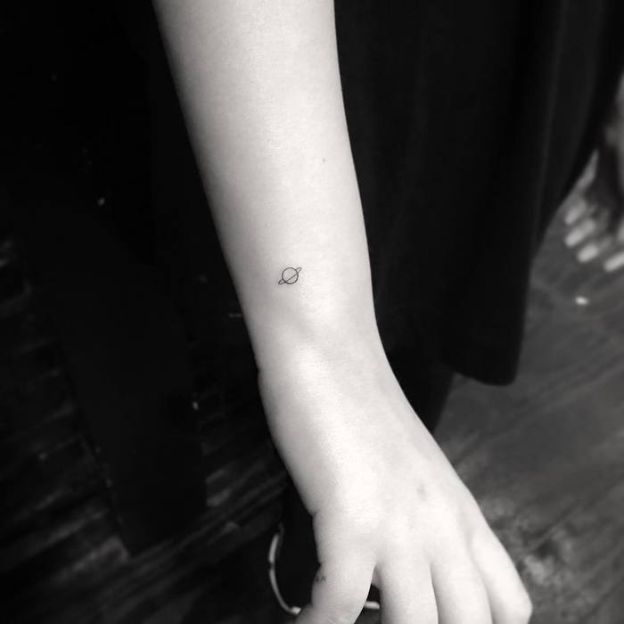 Micro Planet Tattoo on Wrist by shortyloco