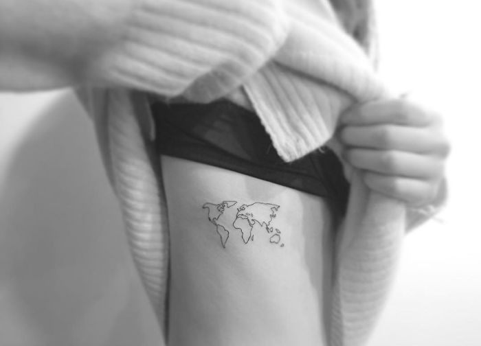 Minimalist World Map Tattoo on Ribcage by Playground Tattoo